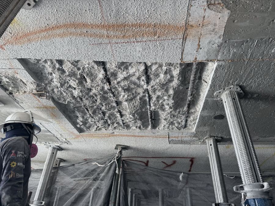 Overhead slab spalling chipped out for structural concrete repair