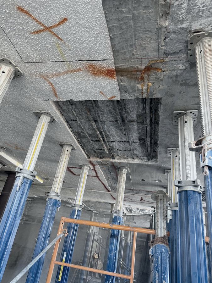 Overhead slab opening exposing reinforcement for repair