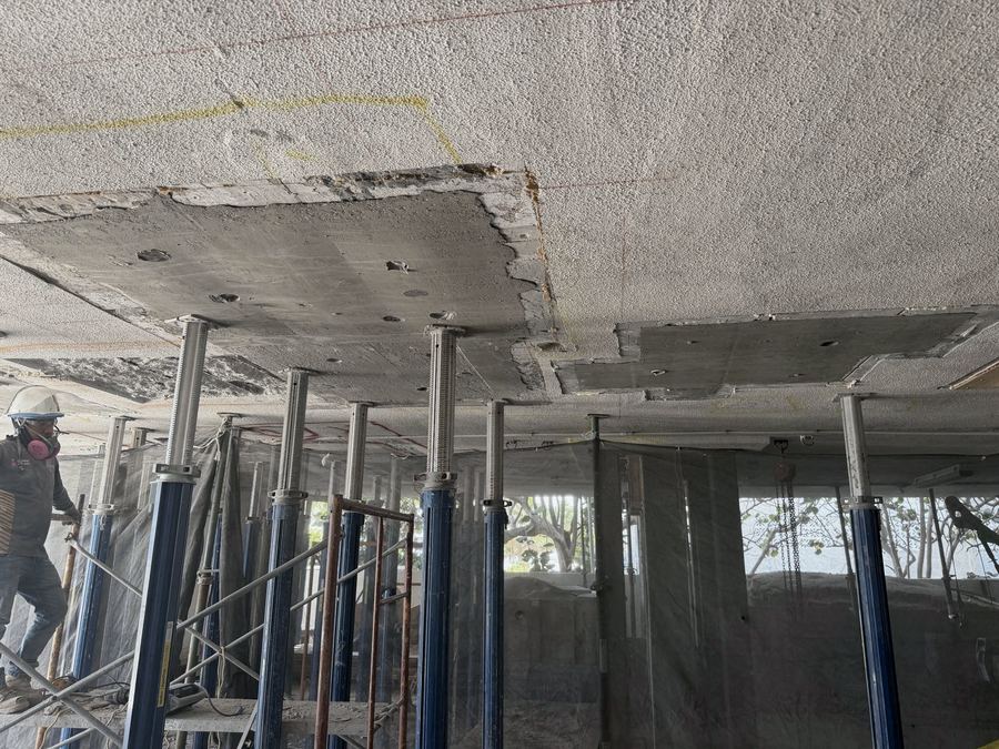 Parking garage slab repair with shoring supporting the deck