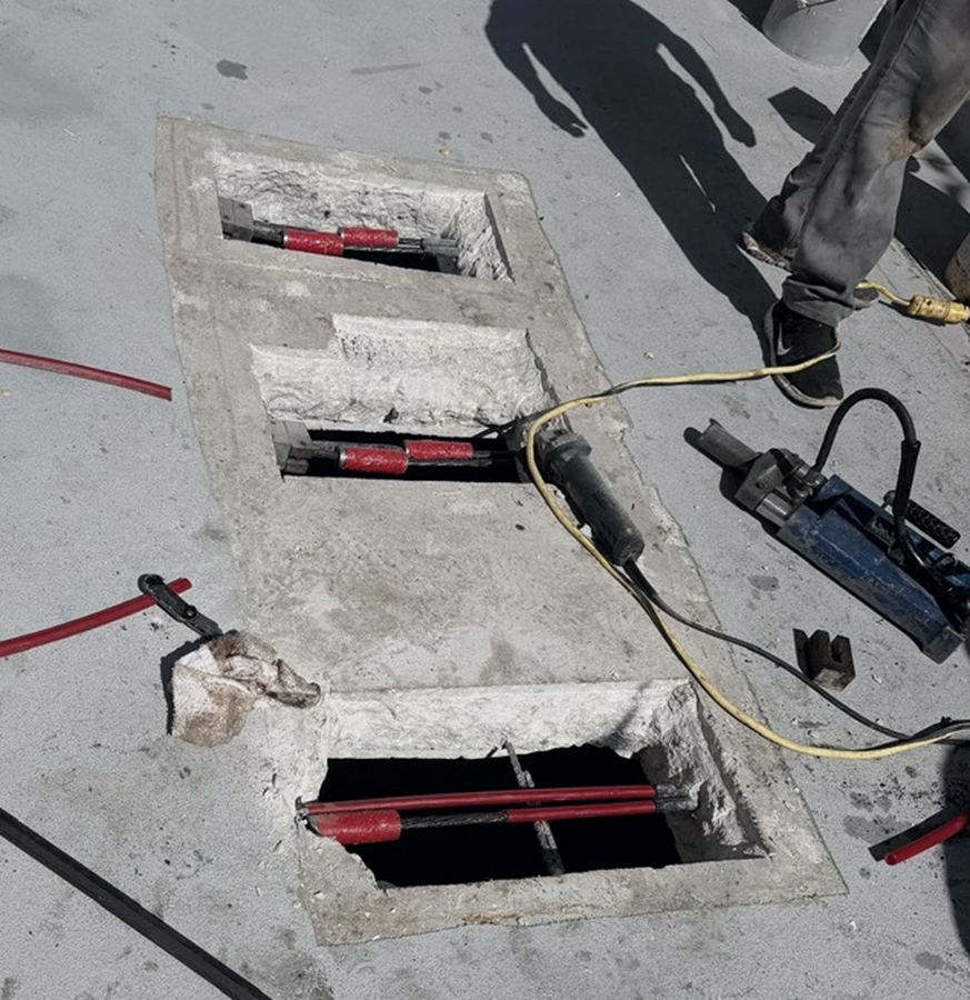 Post-tension cable repair openings cut into a concrete slab