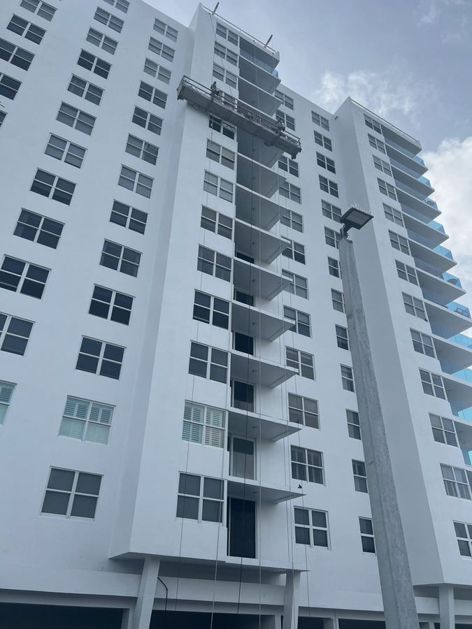 Condominium tower facade work from a suspended platform