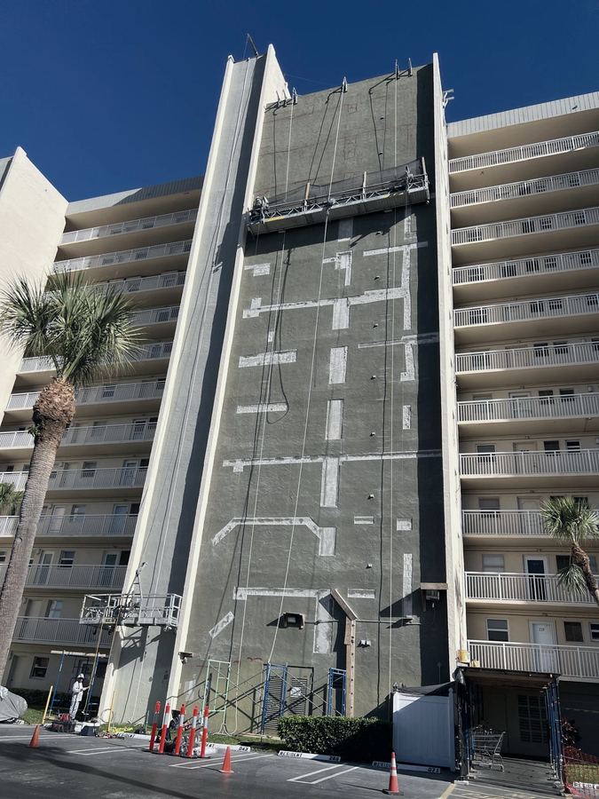 Structural concrete patch repairs across a building facade